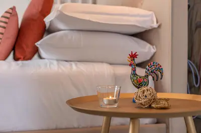 a table with a glass and a candle on a bed at Cornelia cozy home in Rome