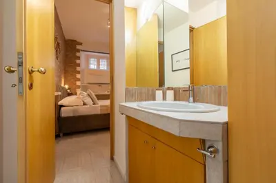 a bathroom with a sink and a mirror at Pearl of Circo Massimo in Rome