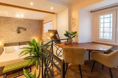 a living room with a dining room table and a bed at Pearl of Circo Massimo in Rome