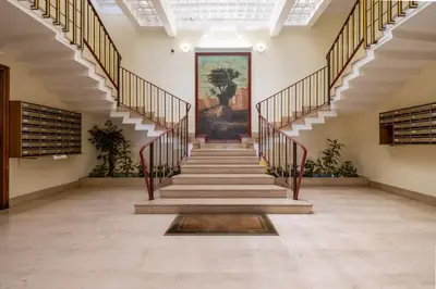 a staircase in a building with a painting on the wall at Casa Preziosa in Metro Piramide in Rome