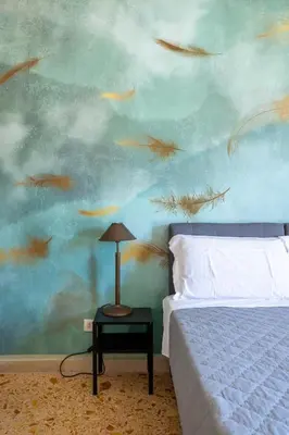 a bedroom with a bed and a painting of fish at Casa Preziosa in Metro Piramide in Rome