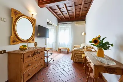 a living room with a dresser and a mirror at La Perla di Trevi in Rome