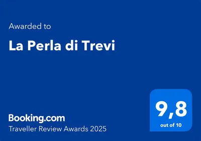 a blue screen with the text awarded to la pella dhruvtra da at La Perla di Trevi in Rome