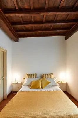 a bedroom with a large bed with yellow pillows at La Perla di Trevi in Rome