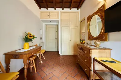 a bathroom with a vanity and a mirror and a table at La Perla di Trevi in Rome