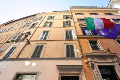 a building with two flags flying in front of it at La Perla di Trevi in Rome