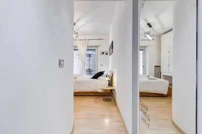 a hallway leading to a bedroom with two beds at Aventino Industrial Loft in Rome