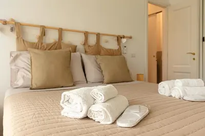 a bed with towels on top of it at Bright and cozy apartment near the Vatican city in Rome