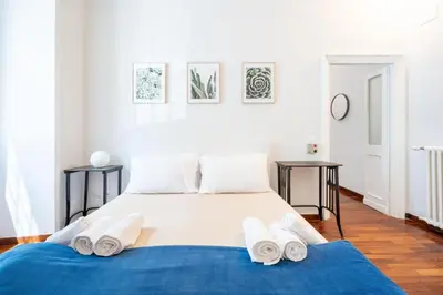 a bedroom with a large bed with towels on it at Elegante Appartamento con Giardino, Vicino al Centro di Roma e Stadio Olimpico in Rome