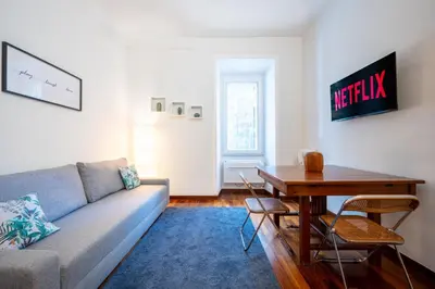 a living room with a couch and a table at Elegante Appartamento con Giardino, Vicino al Centro di Roma e Stadio Olimpico in Rome