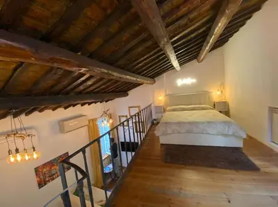 a bedroom with a bed in a room with wooden floors at Home Bella Roma centro storico in Rome