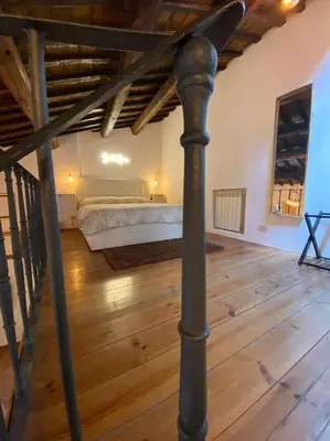 a bedroom with a bed and a wooden floor at Home Bella Roma centro storico in Rome
