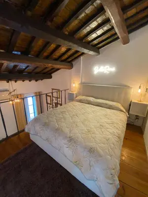 a bedroom with a large bed in a room with wooden ceilings at Home Bella Roma centro storico in Rome