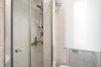 a shower with a glass door in a bathroom at White Flat San Lorenzo in Rome