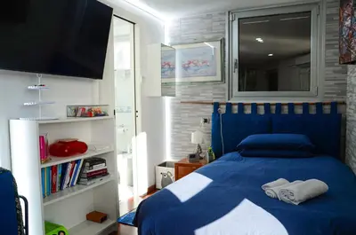 a bedroom with a blue bed with towels on it at Magnifico 122 Apartment in Rome