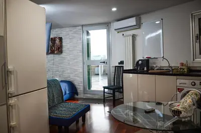 a kitchen with a glass table and a kitchen with a window at Magnifico 122 Apartment in Rome