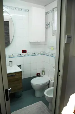a bathroom with a toilet and a sink at Magnifico 122 Apartment in Rome