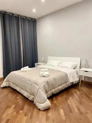 a bedroom with a large bed with two towels on it at Ale home in Rome