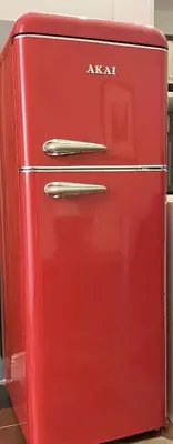 an old red refrigerator with aaa written on it at Ale home in Rome