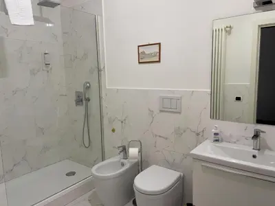 a bathroom with a toilet and a sink and a shower at Ale home in Rome