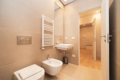 a bathroom with a white toilet and a sink at Green Hill Buddyrent's in Rome