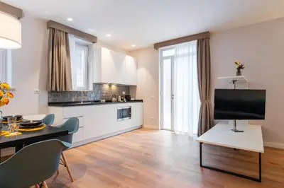 a kitchen and living room with a television on a table at Major House - Luxury Apartments in Rome by Hostand in Rome