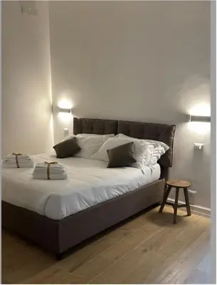 a bed with white sheets and pillows in a room at Cola di Rienzo 243 Relais-B in Rome
