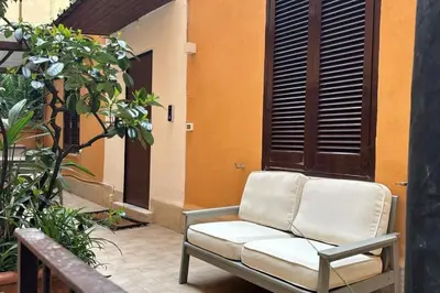 a couch sitting on a patio in front of a building at Cola di Rienzo 243 Relais-B in Rome