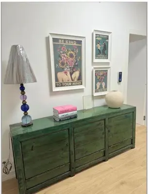 a green dresser in a room with a lamp and pictures at Cola di Rienzo 243 Relais-B in Rome