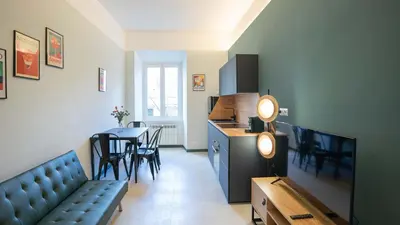 a living room with a couch and a kitchen with a table at EasyTopStay - Crescenzio Stylish Apartment in Rome
