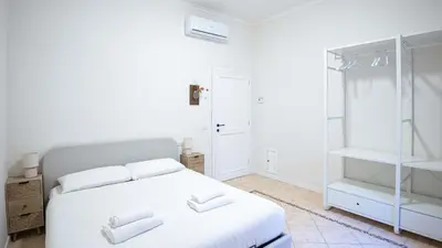 a bedroom with a white bed with two white towels at EasyTopStay - Crescenzio Stylish Apartment in Rome
