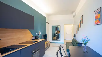 a kitchen with a counter and a table with chairs at EasyTopStay - Crescenzio Stylish Apartment in Rome