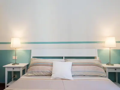 a bedroom with a bed with two lamps on two tables at Apartment Vatican - Residenza Argilla by Interhome in Rome
