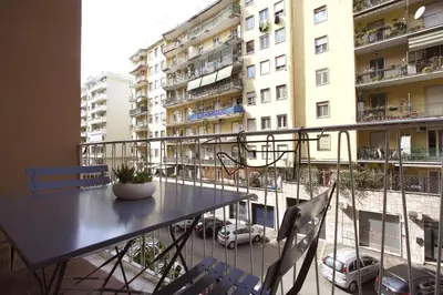 a balcony with a table and chairs and a view of a city at Aniene Holiday House in Rome