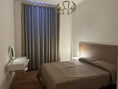 a bedroom with a bed and a sink and a window at luna in trastevere apartamento in Rome
