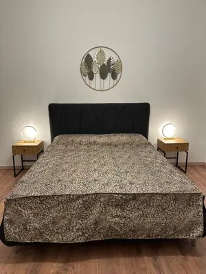 a bedroom with a bed and two night stands at luna in trastevere apartamento in Rome