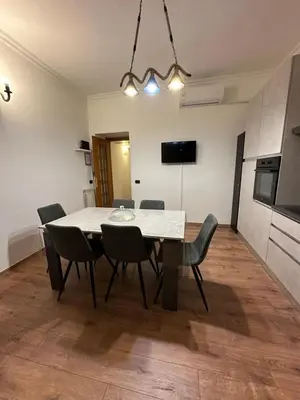 a kitchen and dining room with a table and chairs at luna in trastevere apartamento in Rome