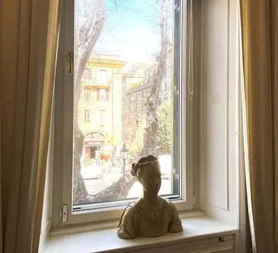 a red bird sitting on a shelf next to a radio at Vatican Modern Art apartment in Rome