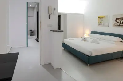 a bedroom with a bed and a blue couch at Restart Accommodations Trevi in Rome