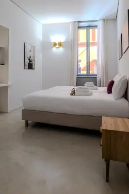a large bed in a white room with a window at Restart Accommodations Trevi in Rome