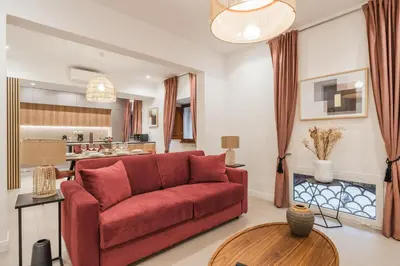 a living room with a red couch and a table at The Best in Rome Orologio in Rome