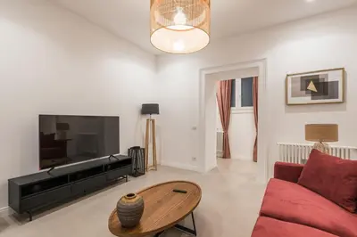 a living room with a couch and a flat screen tv at The Best in Rome Orologio in Rome