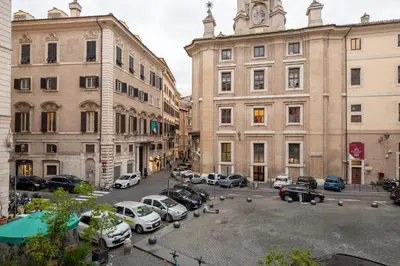 a group of cars parked in a parking lot between buildings at The Best in Rome Orologio in Rome
