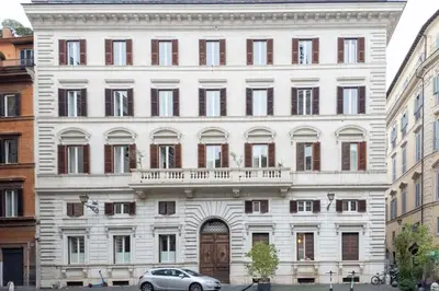 a large white building with a car parked in front of it at The Best in Rome Orologio in Rome