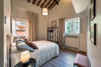 a bedroom with a bed and a window at Attico le Stelle de Roma in Rome