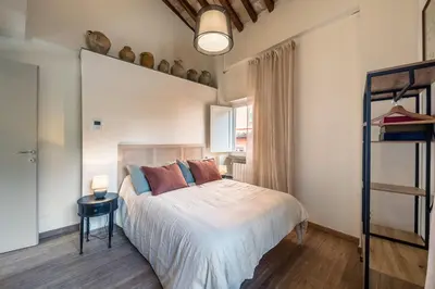 a bedroom with a bed and a table with a lamp at Attico le Stelle de Roma in Rome