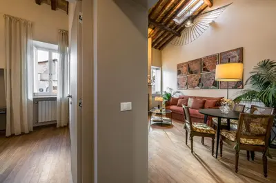a living room with a couch and a table at Attico le Stelle de Roma in Rome