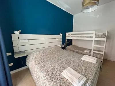 a bedroom with two bunk beds and a blue wall at Casa Latina in Rome
