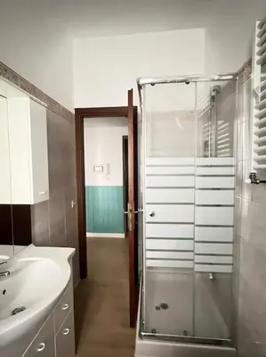 a bathroom with a glass shower and a sink at Casa Latina in Rome