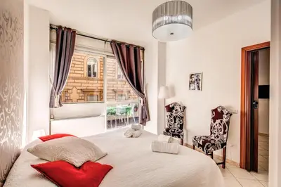 a bedroom with a large bed and a window at M&L Apartments - Ardesia Colosseo in Rome